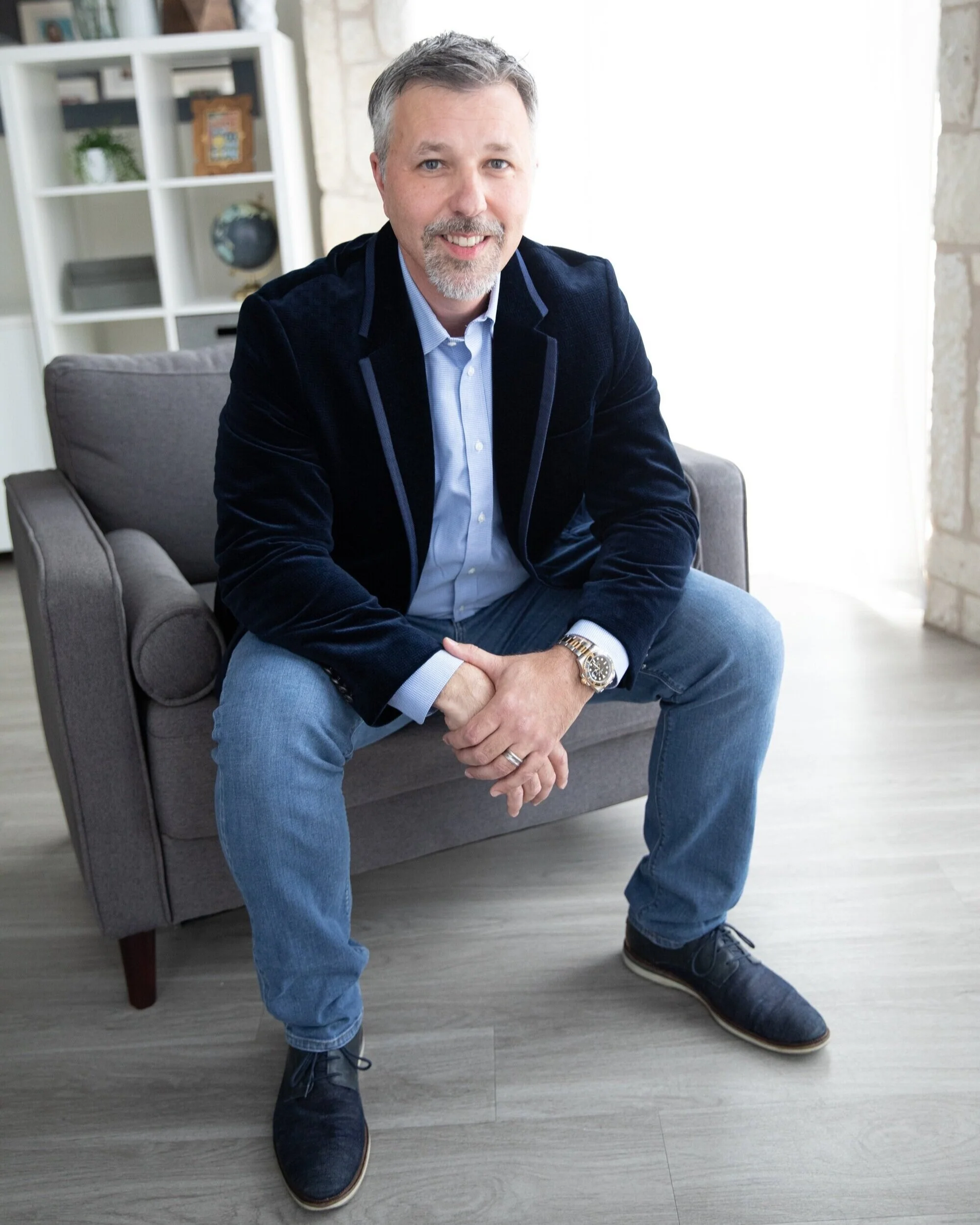 Portrait of a security professional sitting in an office armchair.
