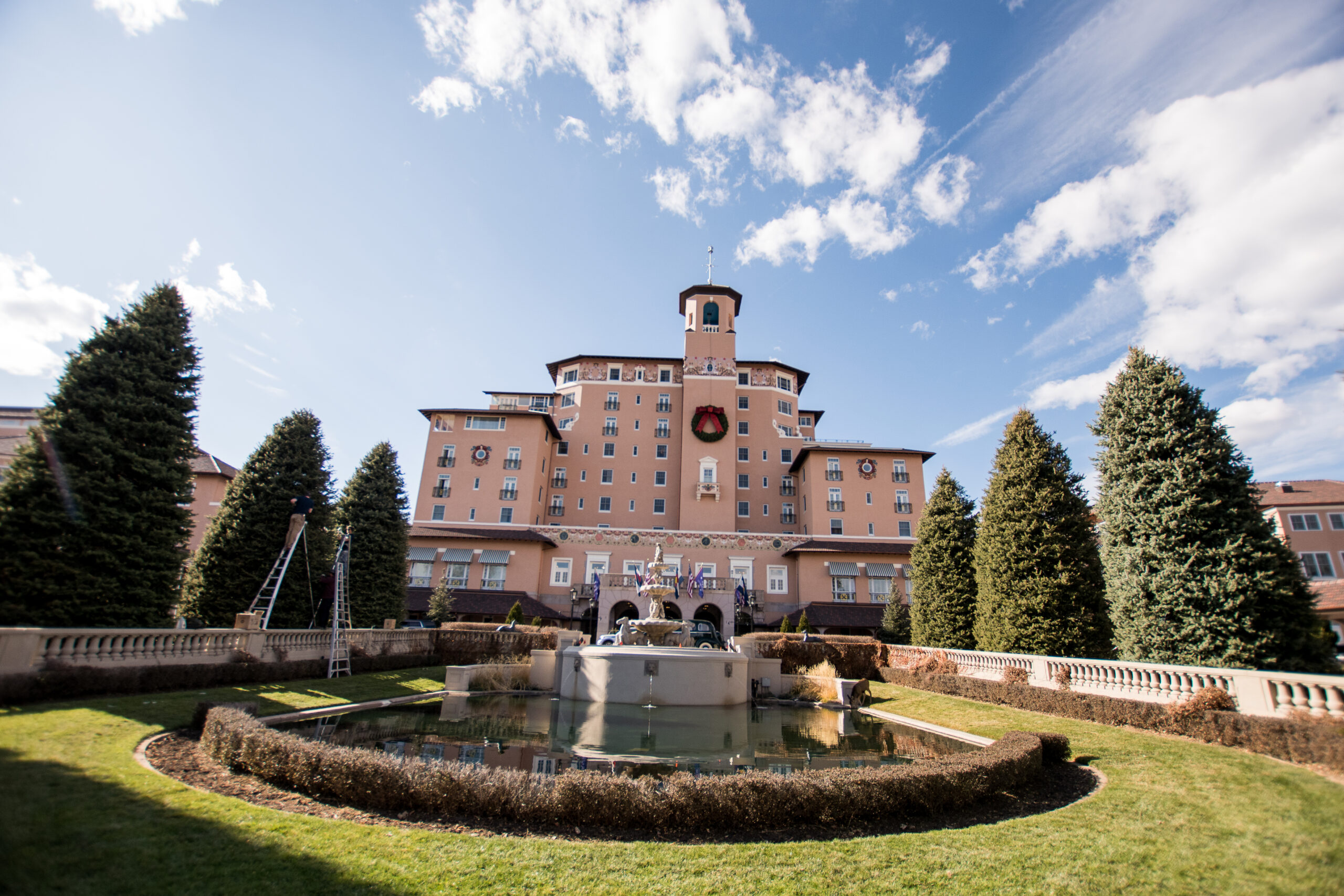Exterior view of the Broadmoor hotel with front fountain and landscaped gardens.